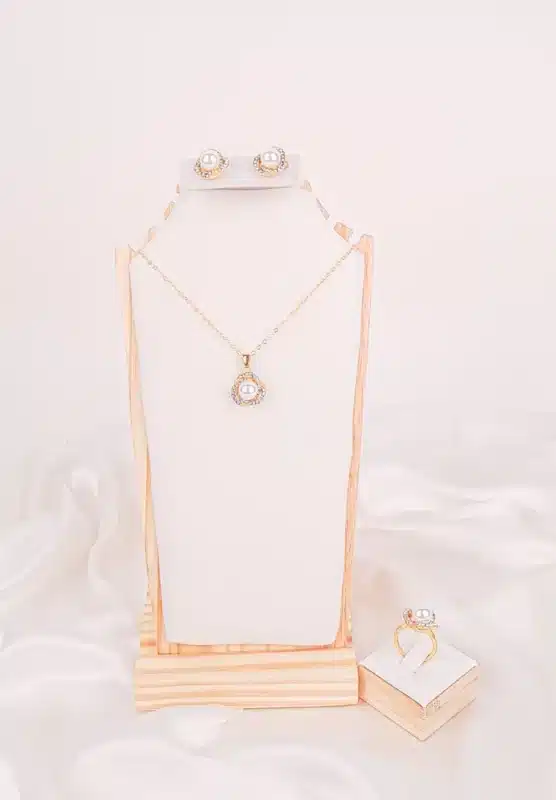 "Jewelry set with pearls and rhinestones—includes pendant necklace, stud earrings, and adjustable band ring. "