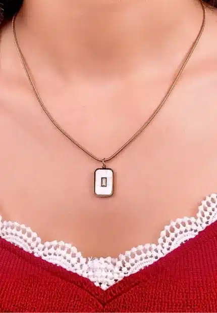 "Rose gold necklace with rectangular cutout pendant in stainless steel. "