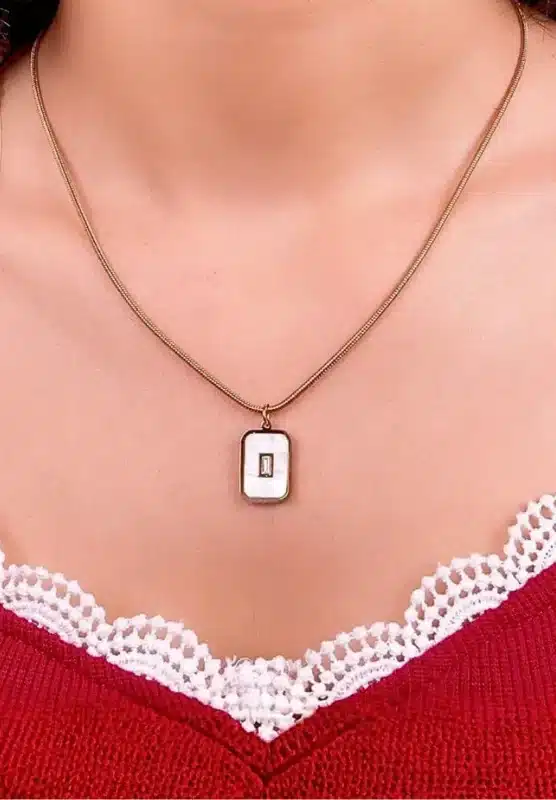 "Rose gold necklace with rectangular cutout pendant in stainless steel. "