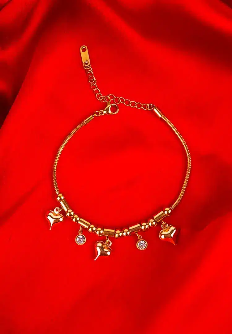 TH-663 Gold bracelet with heart and bead charms on flexible snake chain.