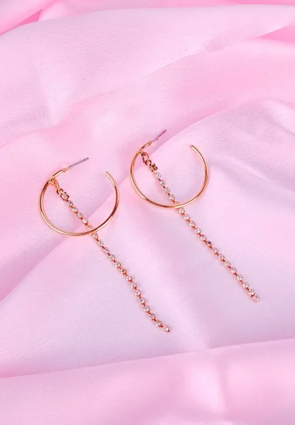 Gold hoop earrings with rhinestone chain drops, featuring polished half hoops and cascading crystals.