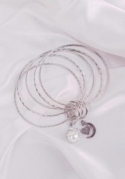 Silver-tone pearl charm bangle set with smooth, twisted, and textured designs in a lightweight slip-on style, perfect for versatile everyday and festive looks.