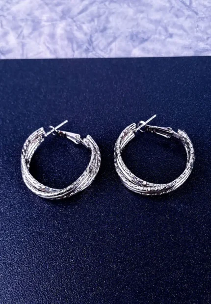 Textured silver hoop earrings with a polished finish and secure push-back closure.