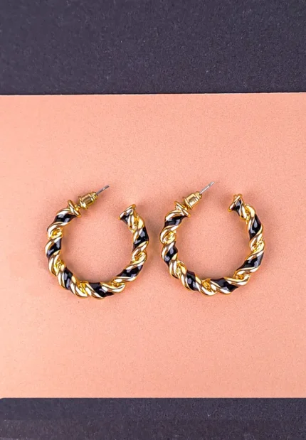 Twisted gold and black hoop earrings with textured finish and push-back closure.