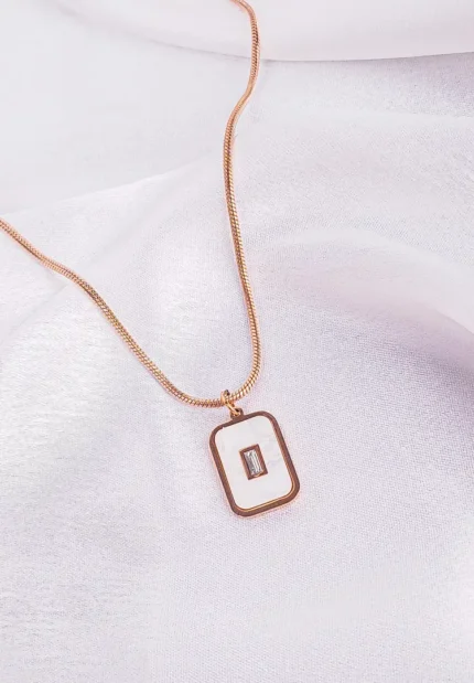 "Rose gold necklace with rectangular cutout pendant in stainless steel. "