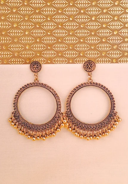 Oxidized golden Chandbali earrings with crescent-shaped hoops, ghungroo detailing, and floral stud top, perfect for festive occasions and weddings.