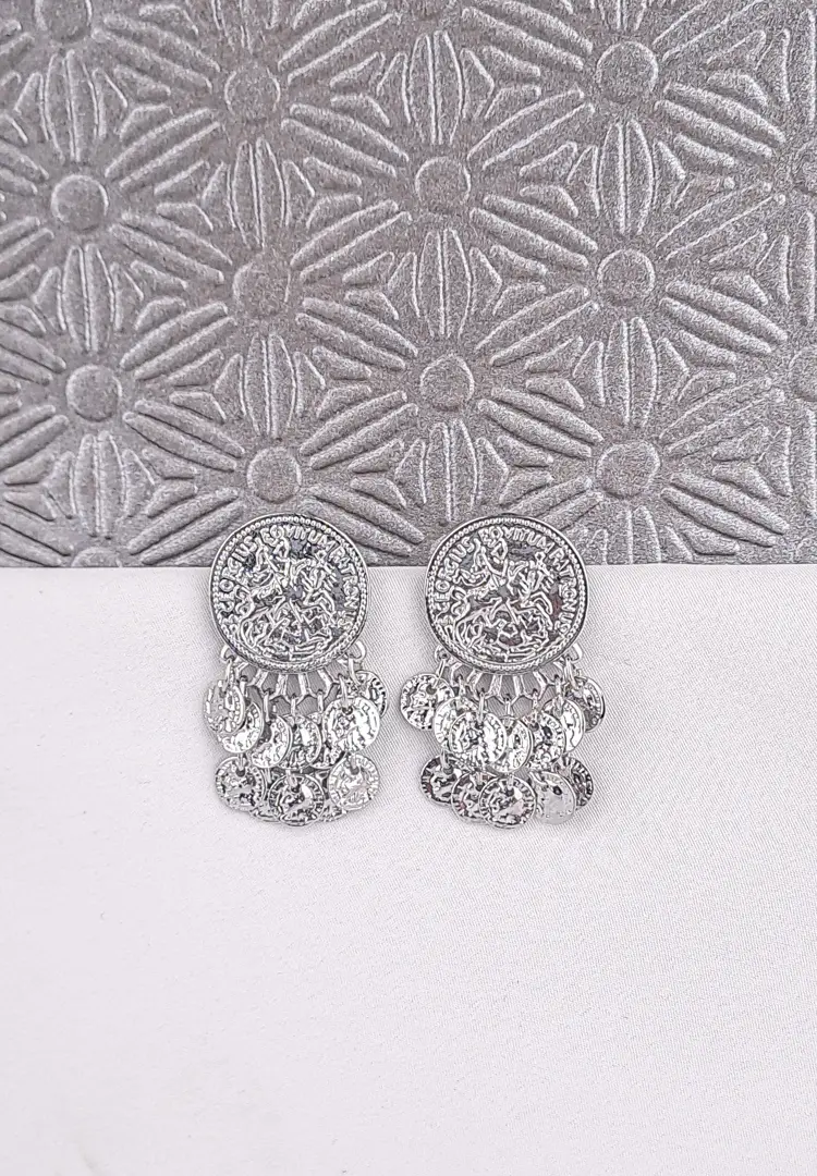 th - 2025-12-03T114034.947 a small, round gold-tone stud earring featuring an embossed or stamped design resembling an ancient coin or medallion, with several small, matching coin charms dangling from the bottom edge.