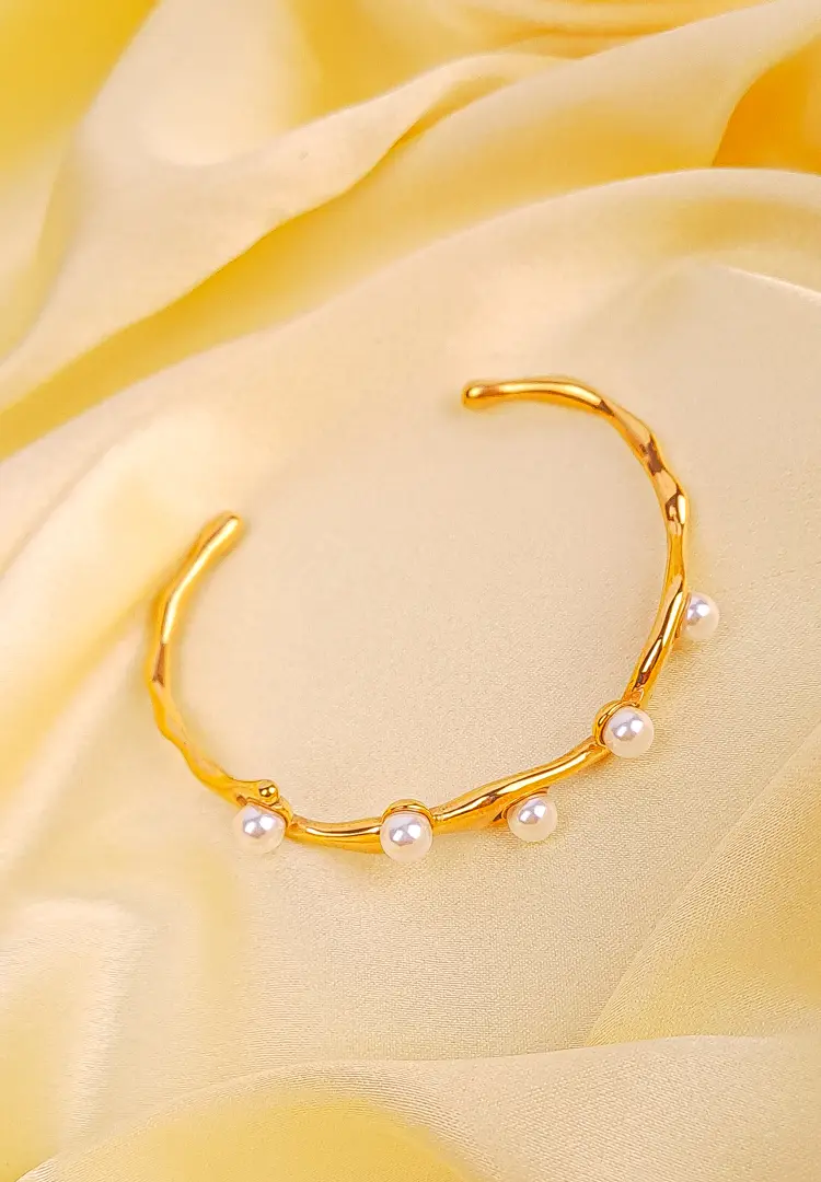th - 2025-12-03T121006.397 Gold wavy open cuff bracelet with faux pearl accents and glossy finish