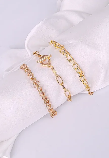 Pack of three gold-tone chain bracelets in assorted link designs with polished finish and secure clasp closures, styled for a layered and statement look