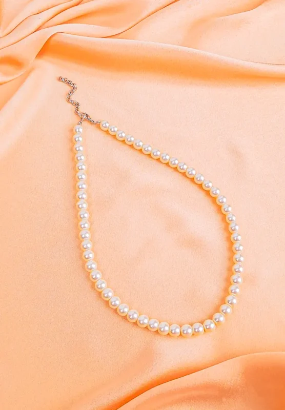 Vintage ivory pearl beaded necklace with lobster clasp, arranged in a gentle curve