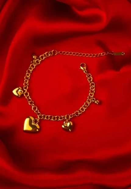 Gold chain bracelet with glossy puffy heart charms, chunky links, and adjustable lobster clasp.