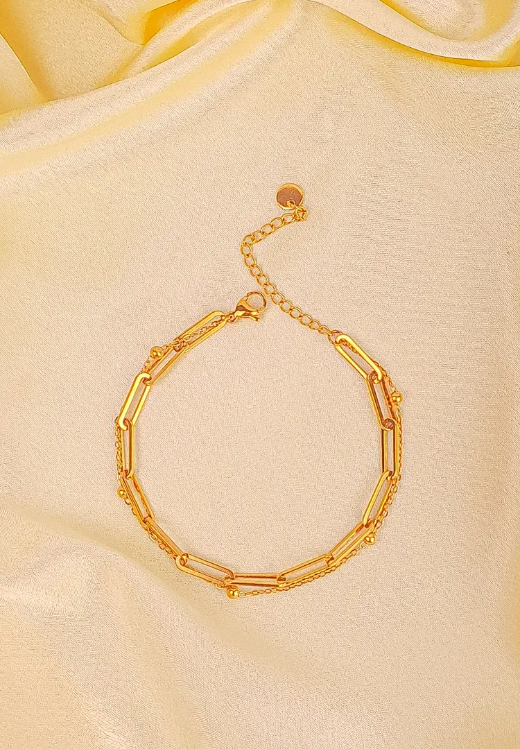 th - 2025-12-03T132825.616 Layered gold bracelet with paperclip link chain and delicate beaded chain, secured with lobster clasp.