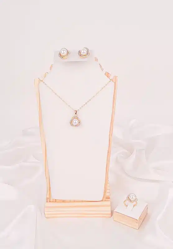 "Jewelry set with pearls and rhinestones—includes pendant necklace, stud earrings, and adjustable band ring. "