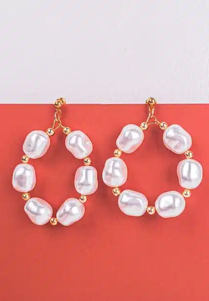 Hoop earrings with baroque pearls and gold-tone beads, featuring polished finish and push-back closure.