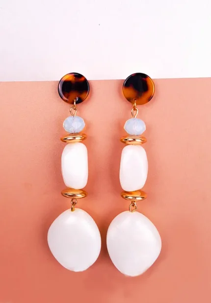 "Tortoise shell stud earrings with blue bead, gold detail, and white organic-shaped stone dangles, finished with a polished closure. "