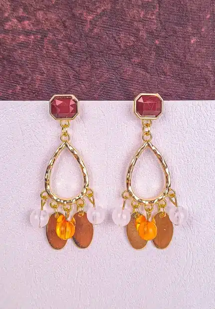 Gold teardrop dangle earrings with faceted gemstones and mixed beads, finished with a textured frame and post-back closure.