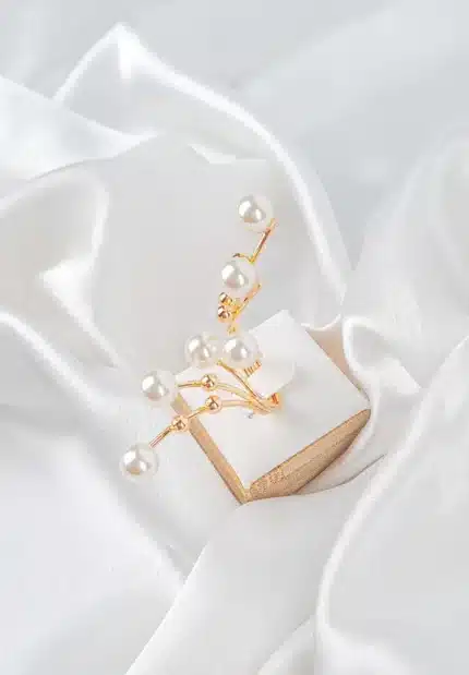 Multi-band adjustable ring with delicate pearl accents on slender metallic branches, polished to a refined finish.