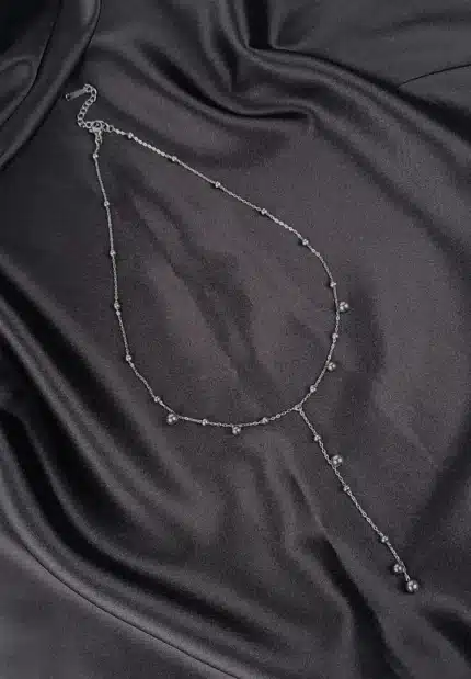 Silver Y-shaped stainless steel necklace with bead details and adjustable lobster clasp.