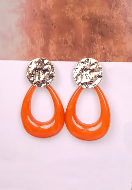 "Gold hammered disc earrings with brown resin teardrop drops, polished textured finish, and push-back closure. "